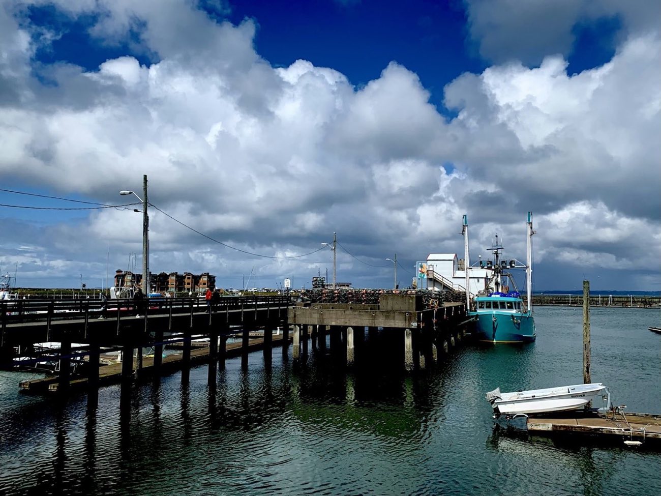 Working harbour dock with crab pots and a moored boat